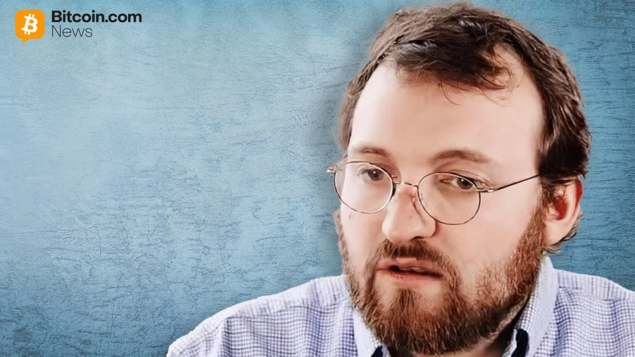 Close-up portrait of Cardano founder Charles Hoskinson wearing glasses against a light blue backdrop.