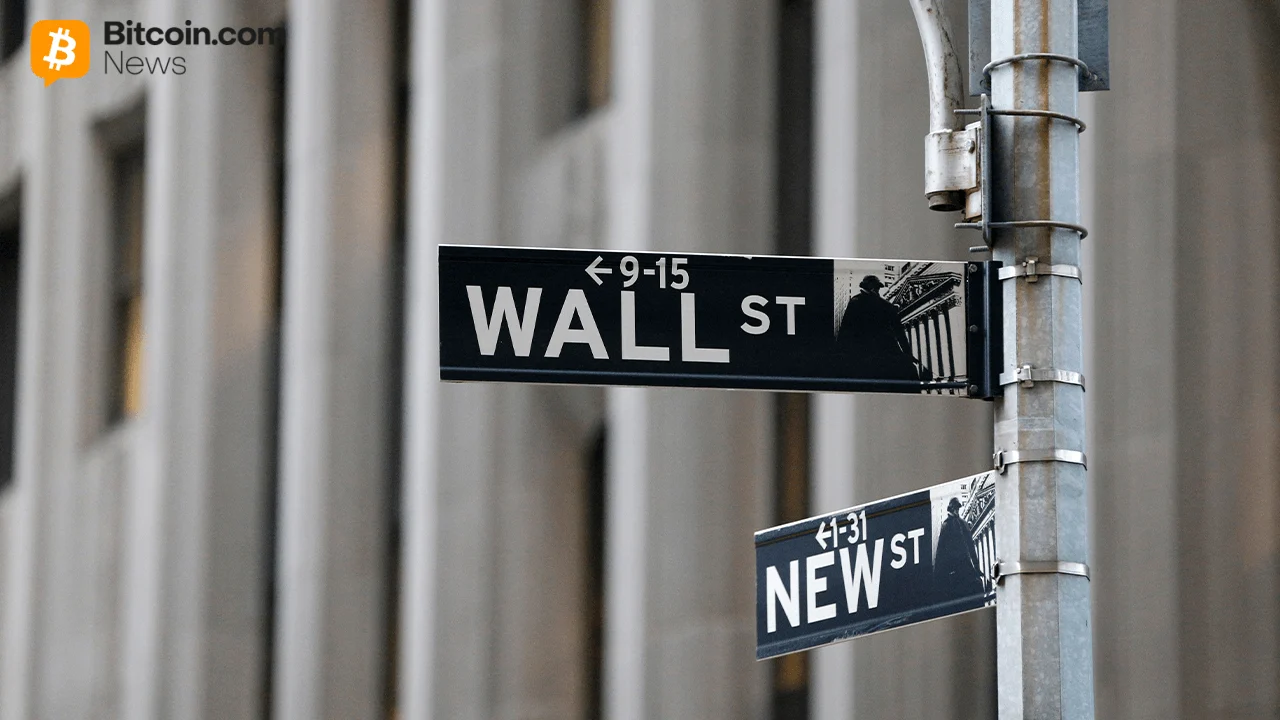 A close-up black-and-white metal directional street sign reading Wall St on a city corner.