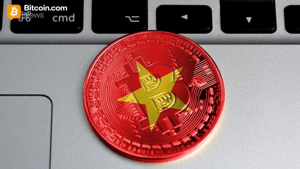 A physical red coin embossed with the national flag of Vietnam resting on a dark computer keyboard layout.