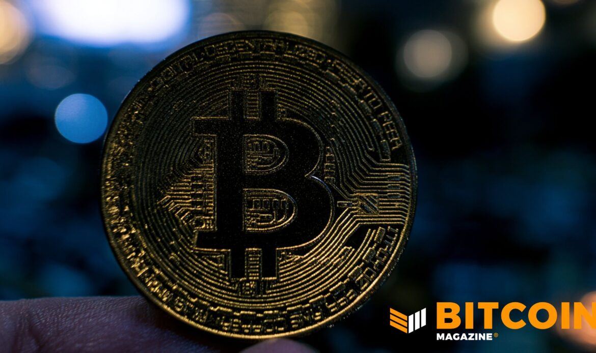 Deep metallic, textured Bitcoin coin positioned inside a dark, moodily lit circular frame setup