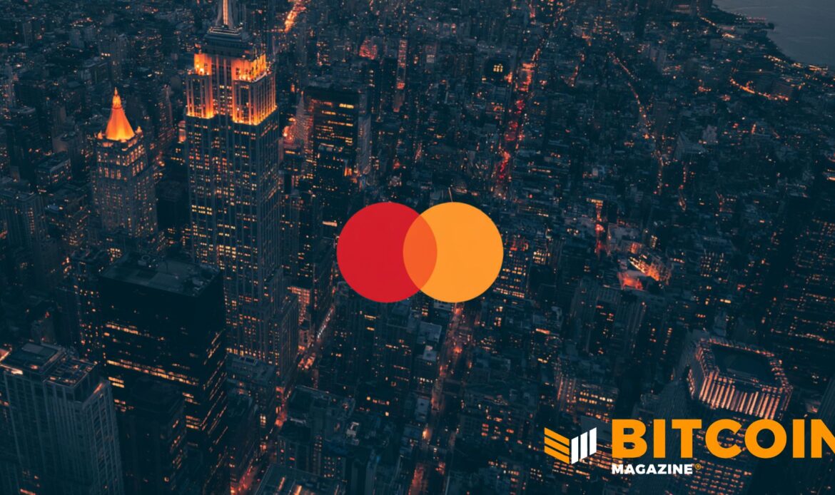The orange and red overlapping circles of the Mastercard corporate logo against a blurry dark city night grid.