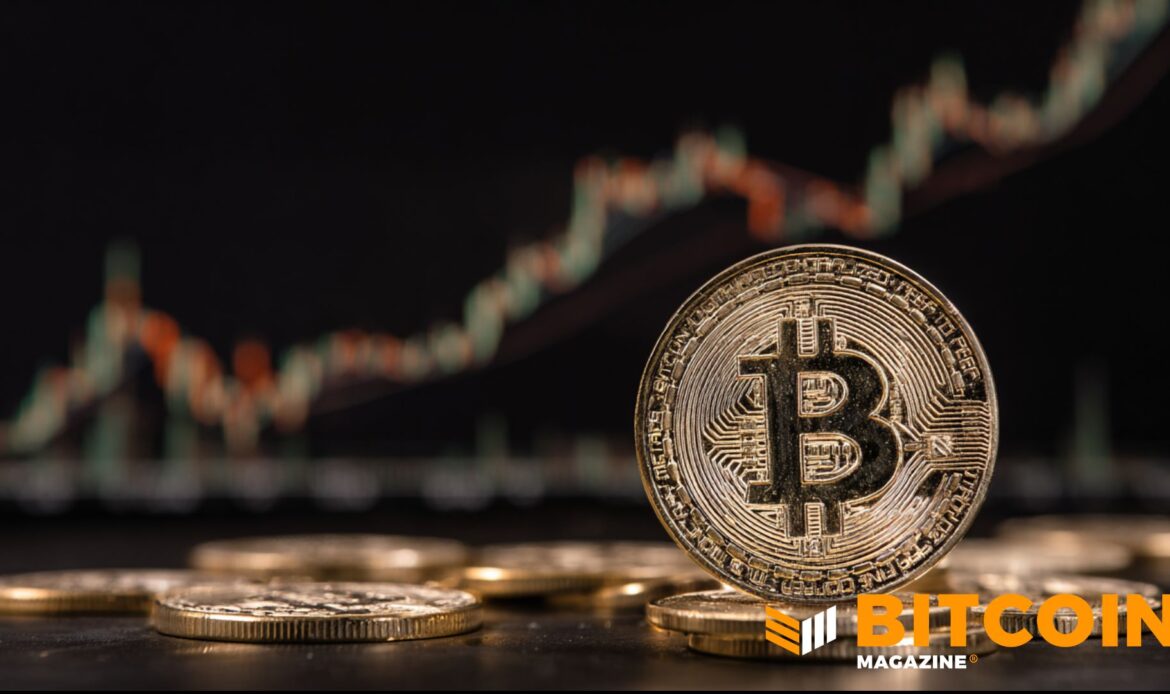 Physical Bitcoin coin sitting on a sleek dark surface next to a faint green upward market chart.