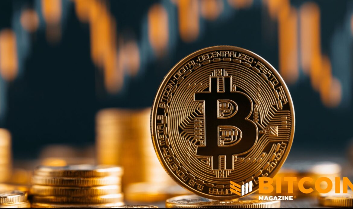 Physical Bitcoin coin positioned in front of blurred golden stock market line charts showing downward price action.